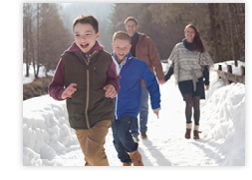 a family has fun during a hike in the snow 