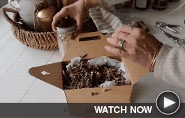a crafter places a jar in a brown package