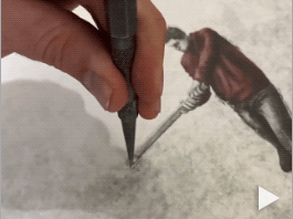 An artist cracks a pane of glass above a painting