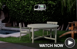 A drone makes a delivery on a patio table